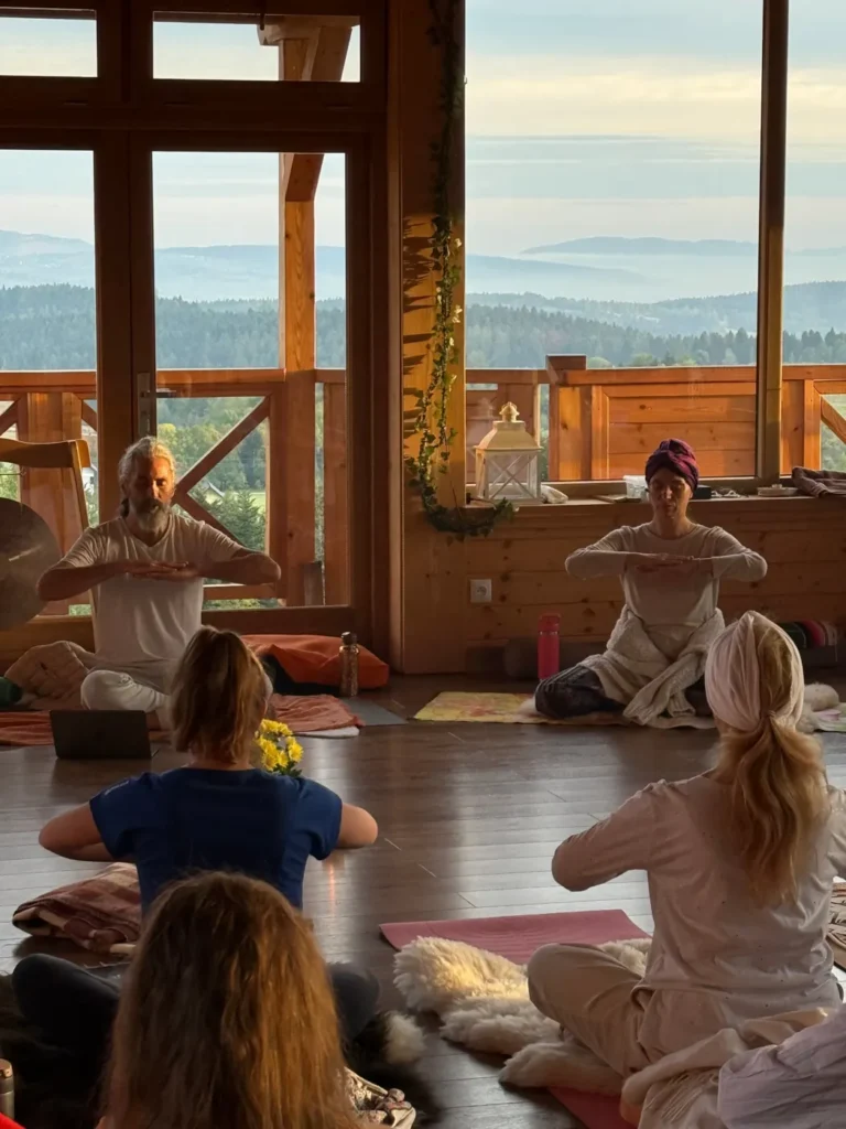 Teachers leading a Kundalini Yoga class with a mountain view